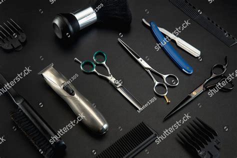 Barber shop equipment set isolated on black table background. Close up sccissors, comb, brushes ...