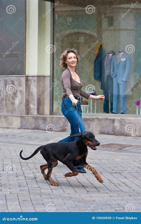 The Woman Walking With A Dog Royalty Free Stock Images - Image: 19434939