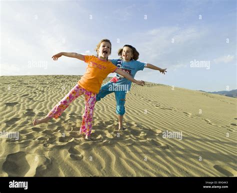 Rants dune children girl cheerfully jokes laughing gesture summer sand ...