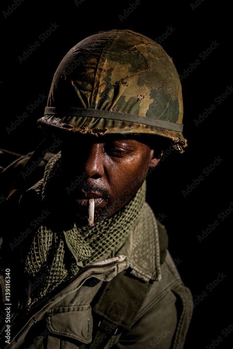 African-American soldier from the Vietnam War suffering with PTSD and smoking a cigarette. Stock ...