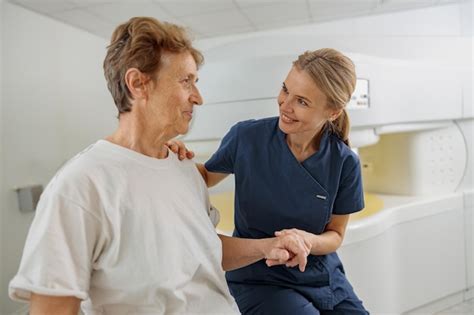 Premium Photo | Doctor radiologist help to patient sit after procedure ...