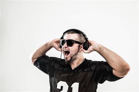 Premium Photo | Creative rapper in the headphones and dark glasses performs a rap song