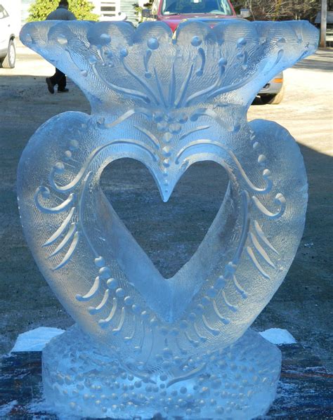 An ice sculpture of a heart-themed flower vase for a centerpiece flower ...