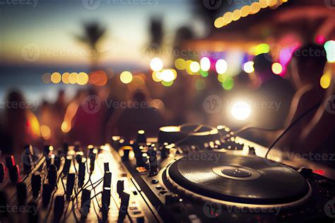 Dj mixing outdoor at beach party festival with crowd of people in ...