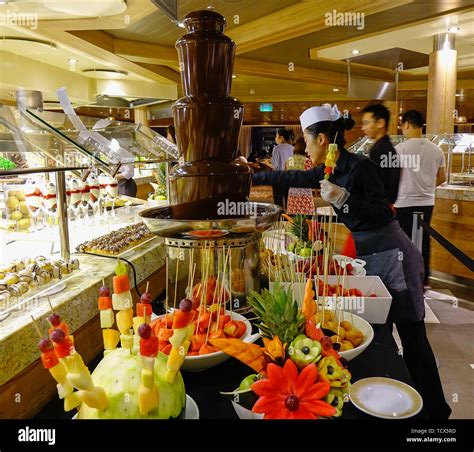 Shanghai, China - Jun 3, 2019. Chocolate fountain with fresh fruits at the buffet restaurant of ...