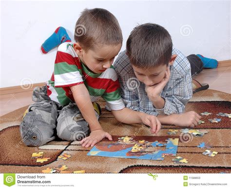 Boys playing the puzzle stock image. Image of play, puzzle - 11588653