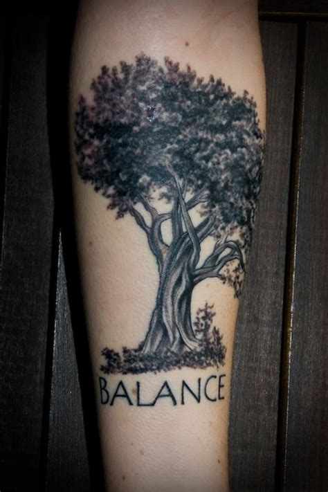 Typical colored forearm tattoo of big tree stylized with lettering ...