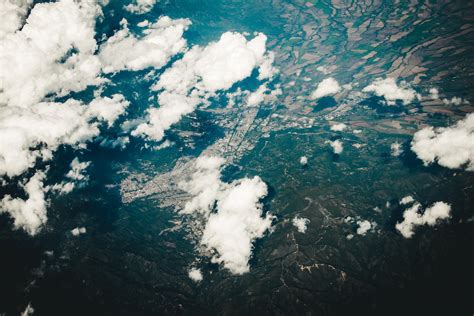 Aerial View of Clouds and Earth's Surface · Free Stock Photo