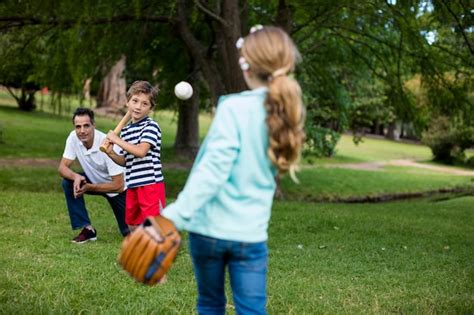 Premium Photo | Family playing baseball in the park