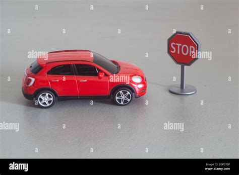 Red toy car and stop roadsign in plastic Stock Photo - Alamy