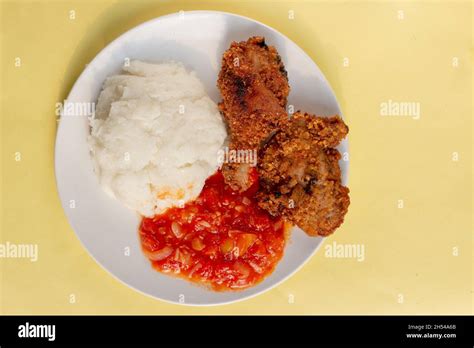 Traditional African corn meal pap staple food, fried chicken and tomato ...