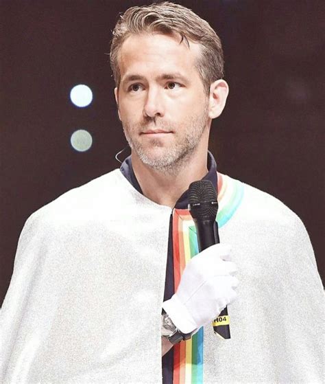 a man wearing a cape and holding a microphone