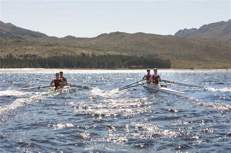 Two double scull rowing boats in water stock photo