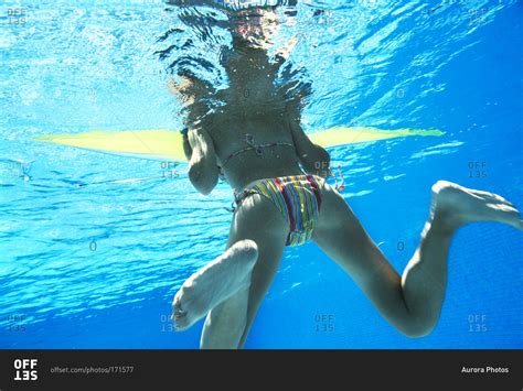 Underwater view of woman in bikini. stock photo - OFFSET