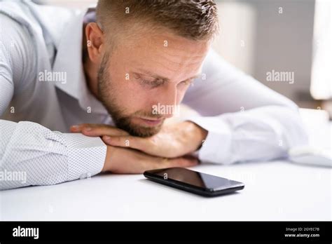 Man Waiting Phone Call At Office Desk Stock Photo - Alamy