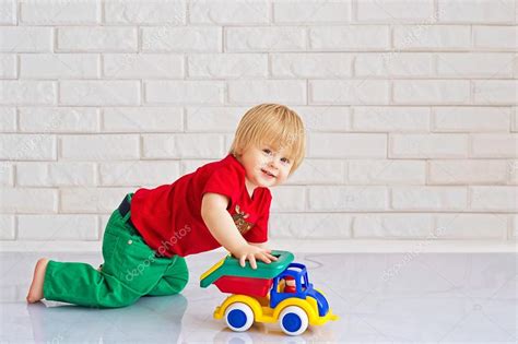 Kid playing with a toy car Stock Photo by ©zoiakostina 25615843