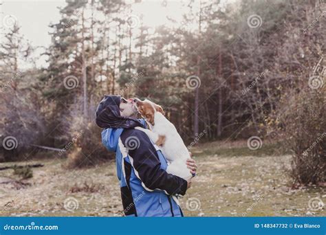 Man with His Cute Small Dog Standing in the Forest at Sunset. Healthy Lifestyle. Hiking Stock ...