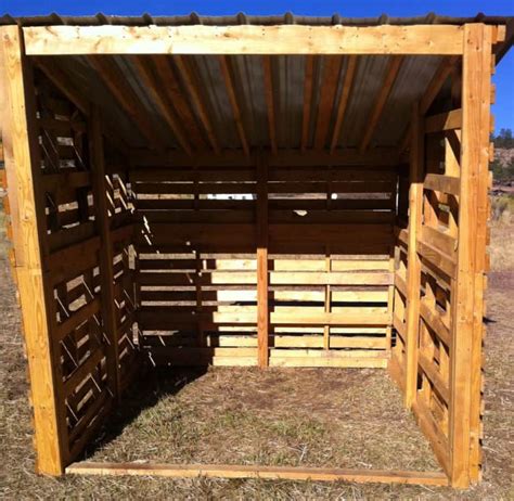 the inside of a wooden shed with wood slats on it's sides and doors open