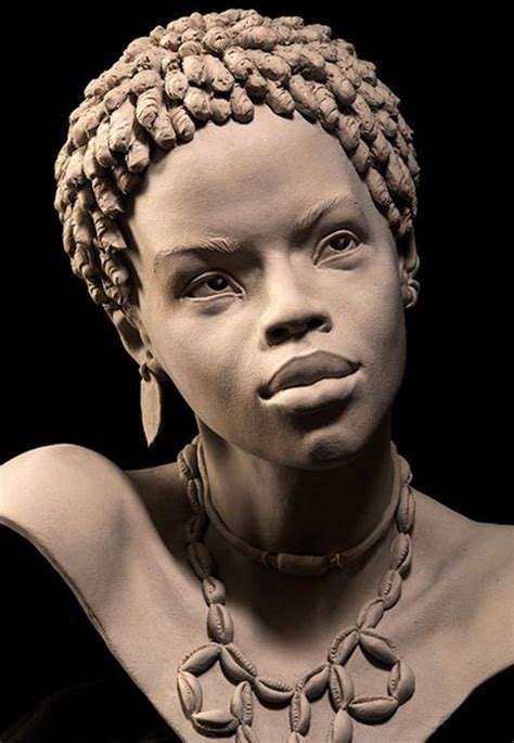 a statue of a woman with braids on her head and necklace around her neck