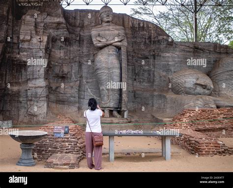 Polonnaruwa, Sri Lanka - 7 AUGUST 2019. Tourist at The granite Buddha ...