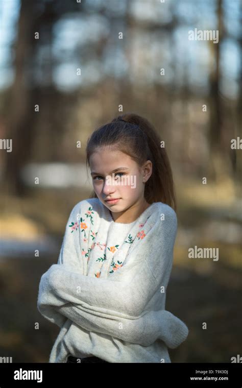 School-age cute girl posing in the Park for a photoshoot Stock Photo ...