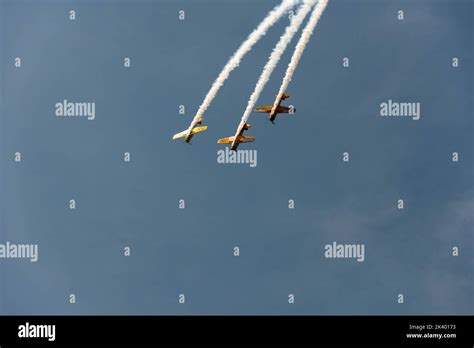 Airplane stunts being performed on the blue sky Stock Photo - Alamy