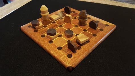 Tak board with game pieces made from mahogany, maple,and walnut