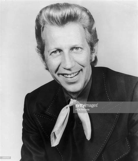 Studio portrait of American country singer Porter Wagoner smiling in ...