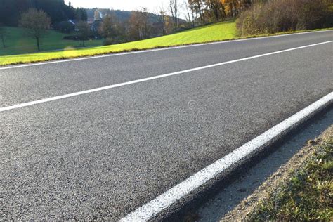 Tarred Country Road Along Weedy River-shore In Sunny Winter Afternoon ...