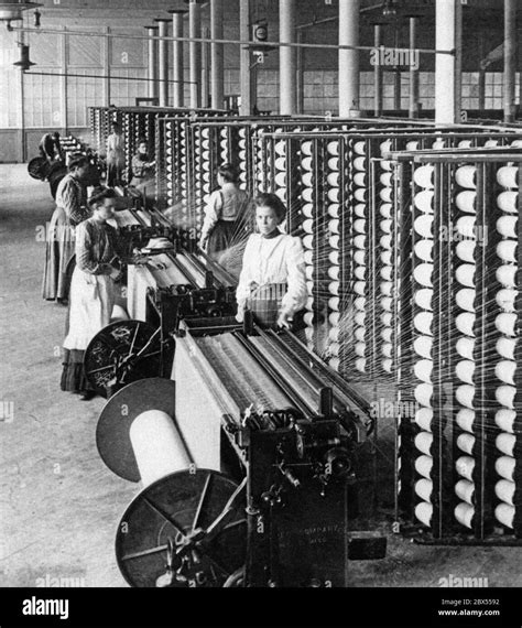 In a cotton spinning mill, female workers operate the spinning machines ...