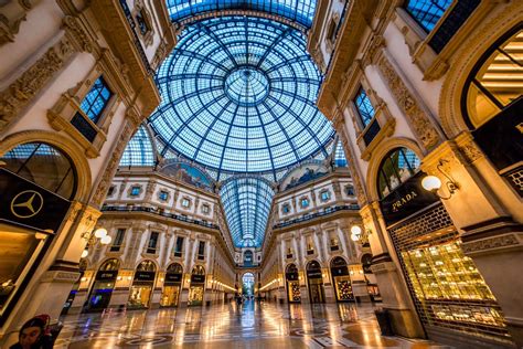 the inside of a shopping mall with people walking around