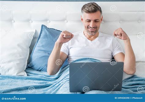 Happy Mature Man Working on Laptop in Bed Stock Photo - Image of browsing, telecommute: 249436590