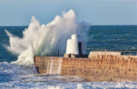 Splash over Portreath Pier | Cornwall Guide