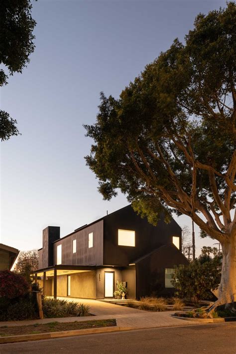 The Black Exterior Of This Barn-Inspired Home Is Contrasted With A ...