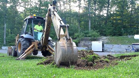 Backhoe Digging Out Hill Side - YouTube