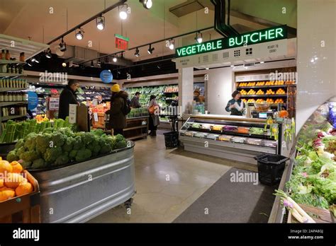 A vegetable butcher in the produce section of a Whole Foods Market in ...