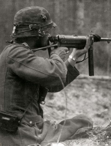 World War II History: A German infantryman aims his MP40 submachine gun on the eastern front, 1941.