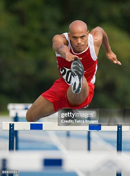 97 Male Athletes Jumping Over Hurdles Front View Stock Photos, High-Res Pictures, and Images ...