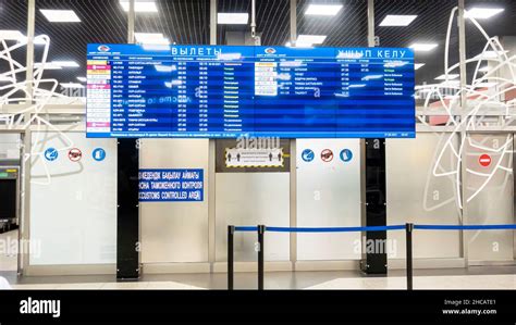 Departures information display with flights information in Almaty airport, Kazakhstan Stock ...