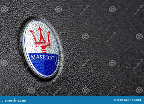 The Trident Logo of the Maserati Car Company on a Shiny Car Covered ...