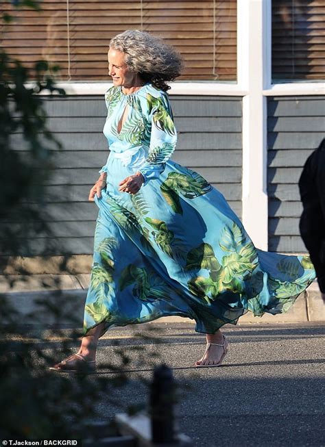 Andie MacDowell, 65, looks elegant in a flowy blue and green print dress for daughter Margaret ...