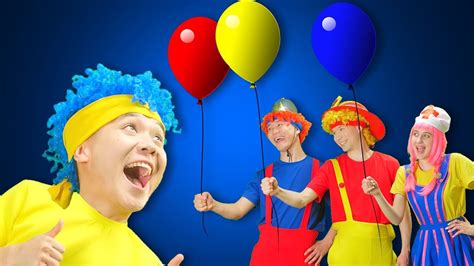 group of people dressed in clown costumes with balloons