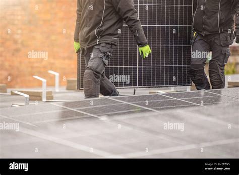 The process of installing solar panels. Solar panel installers work on ...