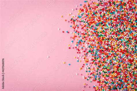 Colored sprinkles on pink background. Stock Photo | Adobe Stock