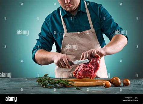 Butcher cutting pork meat on kitchen Stock Photo - Alamy