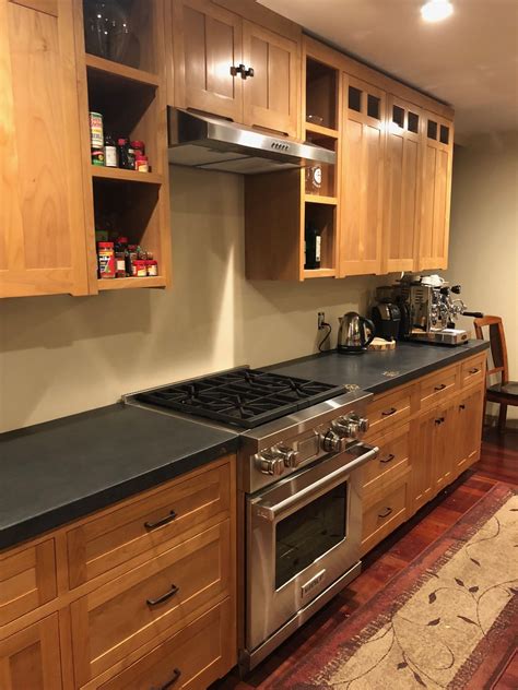 Black concrete countertops in a kitchen with alder inset cabinets. From ...