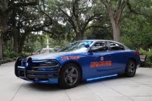 a police car parked in front of some trees