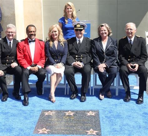 a group of people sitting next to each other on a blue carpet