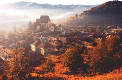 Morning fog over the village of Biertan, Romania photo on Sunsurfer