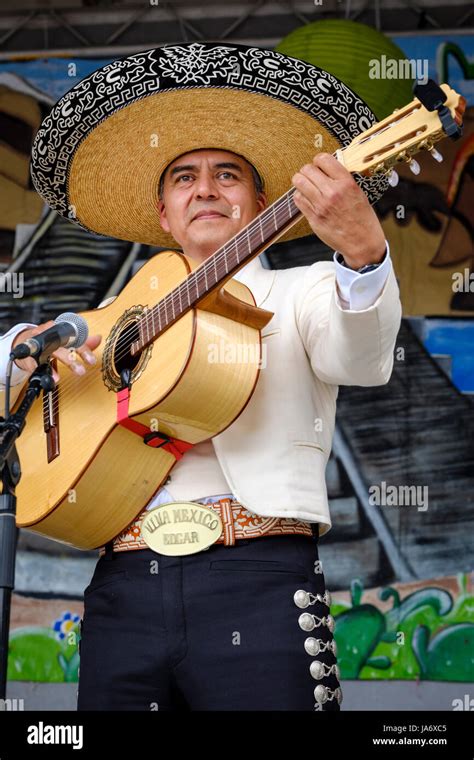 Male Mexican mariachi acoustic guitar player wearing a sombrero hat ...